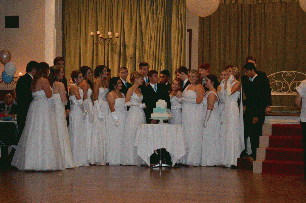 The Debutante's cutting the ceremonial cake
